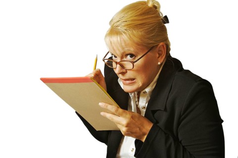 Female erases mistake on her notepad on a white background