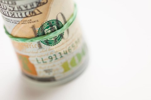 Abstract roll of newly designed U.S. one hundred dollar bills