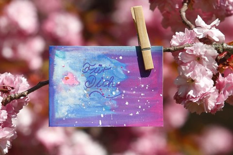 Self painted greeting card hanging in tree