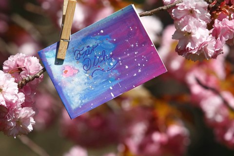 Self painted greeting card hanging in tree
