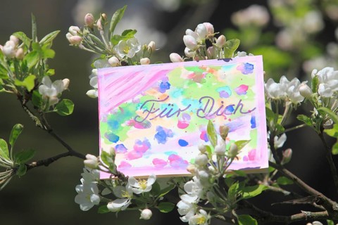 Self painted greeting card hanging in tree