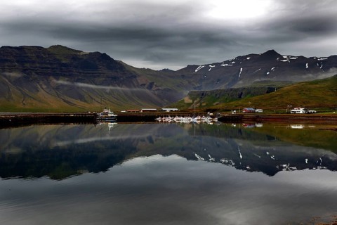 Fishing village in front of mountains