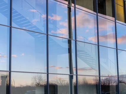 Detail glass front Paul-Loebe-Haus with stairs and reflection sky