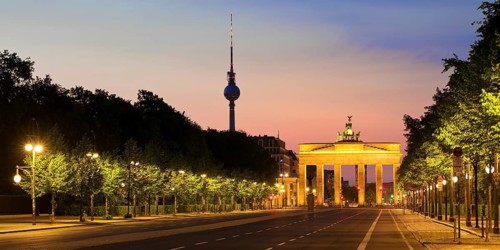 Empty street of June 17 in the morning with Brandenburg Gate and Berlin TV Tower