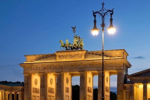 Quadriga on the Brandenburg Gate with old Berlin gas lantern in the evening