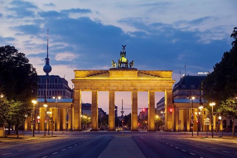 Empty street of June 17 in the morning with the Brandenburg Gate and the Berlin TV Tower