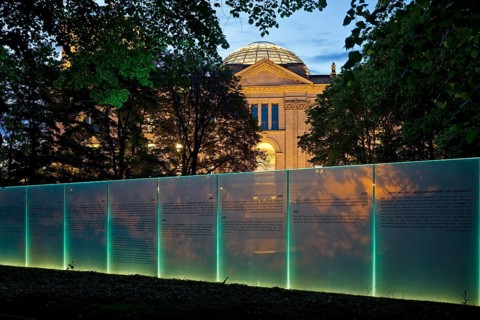 Memorial to the Sinti and Roma of Europe murdered under National Socialism with the Reichstag illuminated in the evening