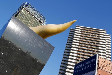 Asahi Breweries headquarters building with the Asahi Flame by french designer Philippe Starck on the east bank of the Sumida River in Sumida district