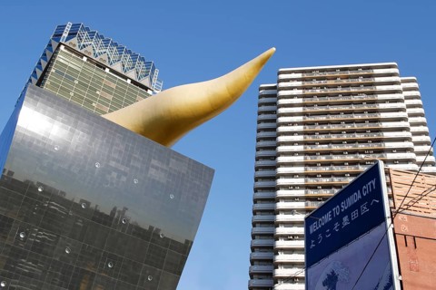 Asahi Breweries headquarters building with the Asahi Flame by french designer Philippe Starck on the east bank of the Sumida River in Sumida district