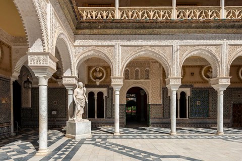 Statue in the courtyard with arches
