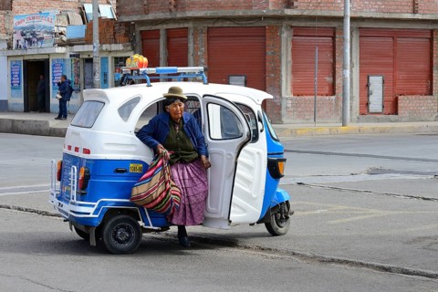 Old indigenous woman getting out of an autorickshaw