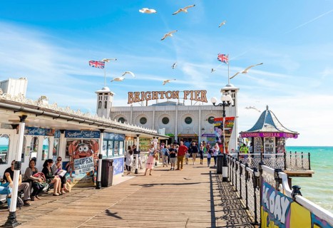 Tourists at Brighton Palace Pier with seagulls