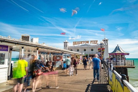 Tourists at Brighton Palace Pier with seagulls