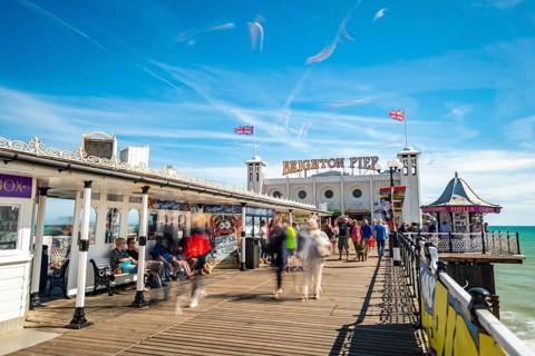 Tourists at Brighton Palace Pier with seagulls