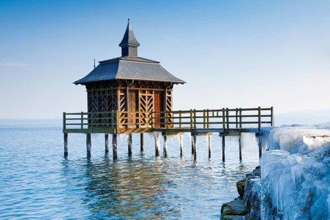 Iced wooden bathhouse on Lake Neuchatel in Gorgier