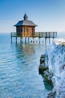 Iced wooden bathhouse on Lake Neuchatel in Gorgier