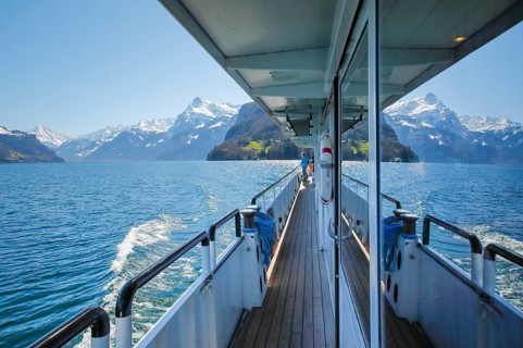 View of the Ruetli meadow during a boat trip on Lake Uri