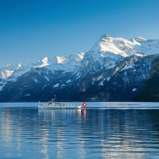 View from Brunnen on a boat on the Lake of Uri in front of the mountain scenery of the Alps of Uri