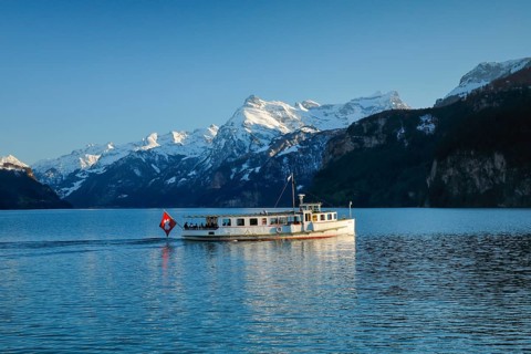 View from Brunnen on a boat on the Lake of Uri in front of the mountain scenery of the Alps of Uri