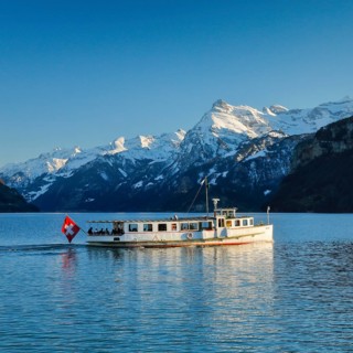 View from Brunnen on a boat on the Lake of Uri in front of the mountain scenery of the Alps of Uri
