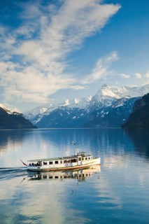 View from Brunnen on a boat on the Lake of Uri in front of the mountain scenery of the Alps of Uri