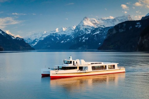 View from Brunnen on a boat on the Lake of Uri in front of the mountain scenery of the Alps of Uri