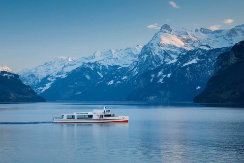 View from Brunnen on a boat on the Lake of Uri in front of the mountain scenery of the Alps of Uri