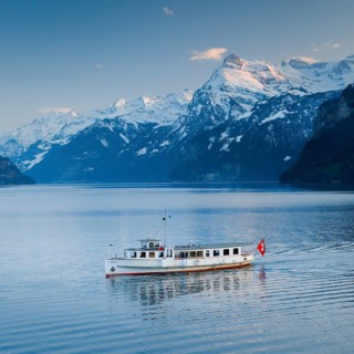 View from Brunnen on a boat on the Lake of Uri in front of the mountain scenery of the Alps of Uri