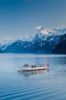 View from Brunnen on a boat on the Lake of Uri in front of the mountain scenery of the Alps of Uri