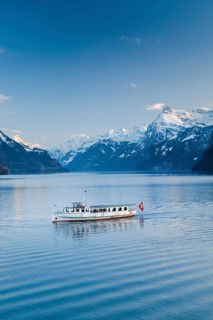 View from Brunnen on a boat on the Lake of Uri in front of the mountain scenery of the Alps of Uri
