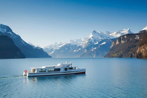 View from Brunnen on a boat on the Lake of Uri in front of the mountain scenery of the Alps of Uri