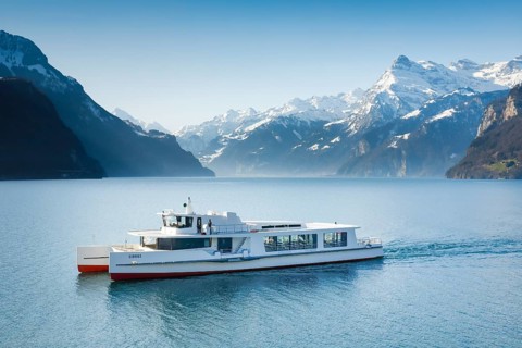 View from Brunnen on a boat on the Lake of Uri in front of the mountain scenery of the Alps of Uri