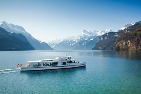 View from Brunnen on a boat on the Lake of Uri in front of the mountain scenery of the Alps of Uri