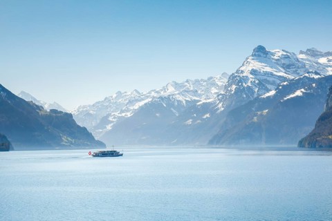 View from Brunnen on a boat on the Lake of Uri in front of the mountain scenery of the Alps of Uri