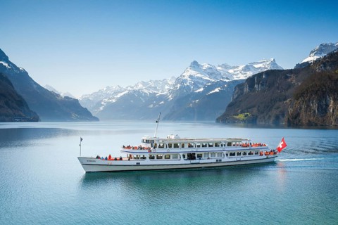 View from Brunnen on a boat on the Lake of Uri in front of the mountain scenery of the Alps of Uri