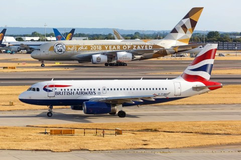 A British Airways Airbus A319 with the registration G-EUPO and an Etihad Airbus A380 at London Heathrow Airport