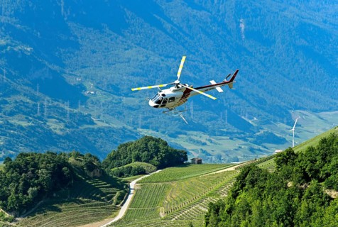 Helicopter Eurocopter AS350 B2 Ecureuil of Air-Glaciers SA sprays pesticides on vineyards in the wine-growing area of Leytron