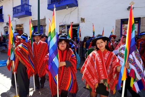 Group with flags in ponchos in the old town