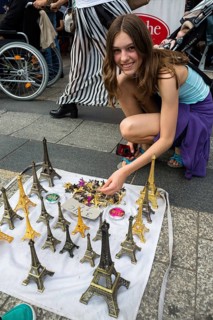Girl buys Eiffel Tower model as souvenir