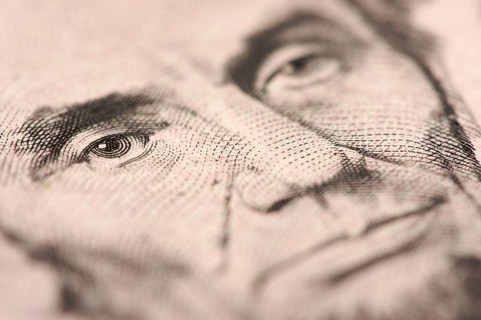 Abstract macro of U.S. five dollar bill's abraham lincoln face with narrow depth of field