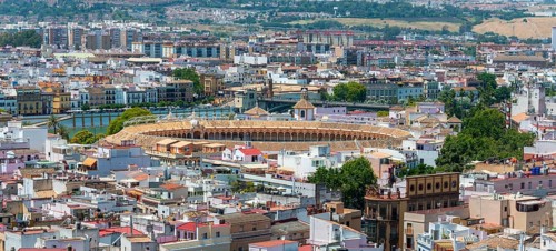 View from above over Seville with bullring Plaza de toros de la Real Maestranza de Caballeria de Sevilla