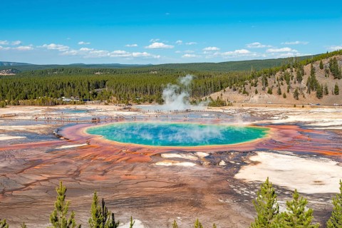 Steaming hot spring with colored mineral deposits and turquoise water