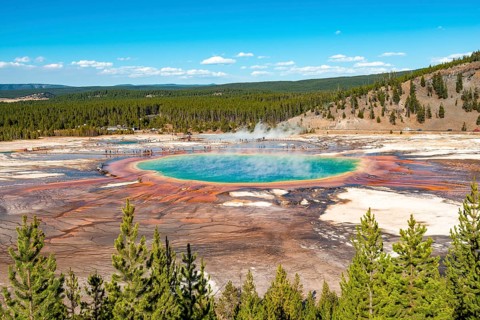 Steaming hot spring with colored mineral deposits and turquoise water