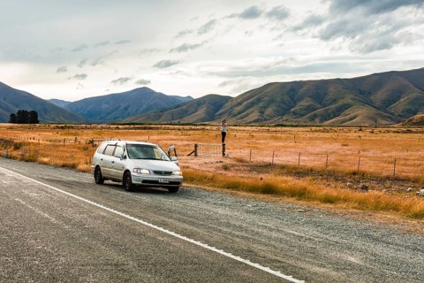Guy with camera next to car