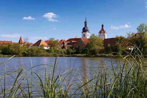 View over the Breiter See lake to the old town with the church St. Sixstus and the town tower