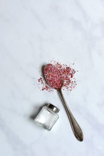 Rose salt in spoon and salt shaker