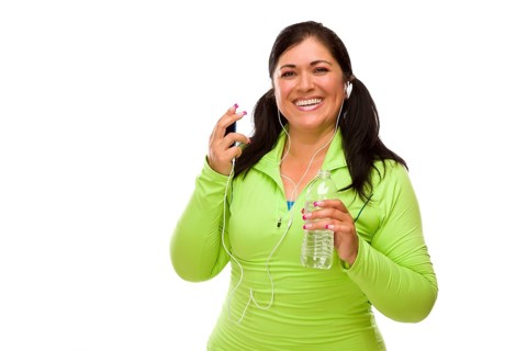 Attractive middle aged hispanic woman in workout clothes with music player