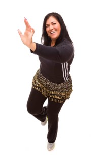 Attractive hispanic woman dancing zumba on a white background