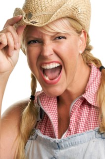 Attractive blond with cowboy hat isolated on a white background