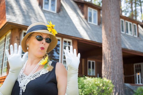 Attractive young woman in twenties outfit near antique house